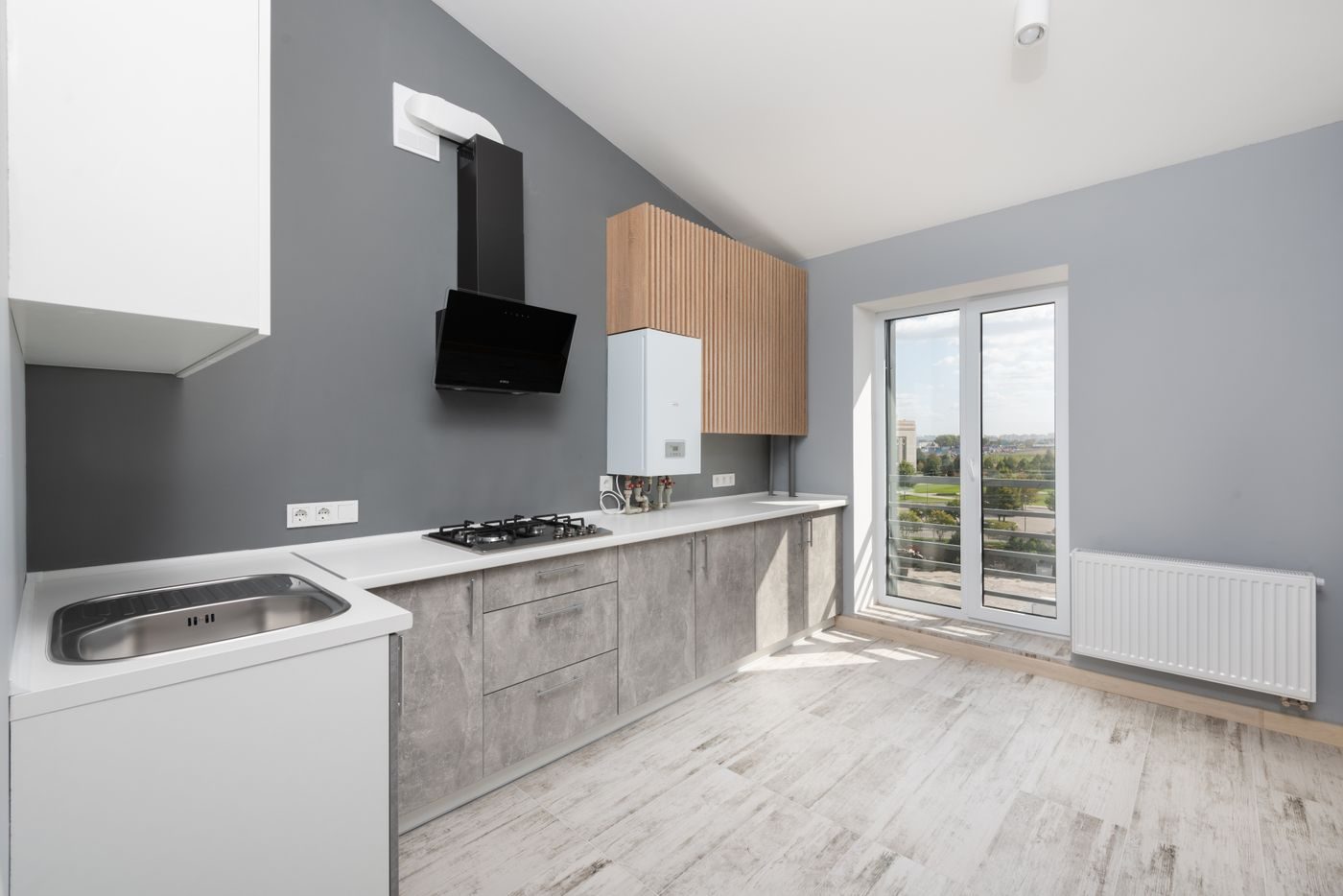 Bright kitchen with a white wall-hung boiler beside the cooker hood